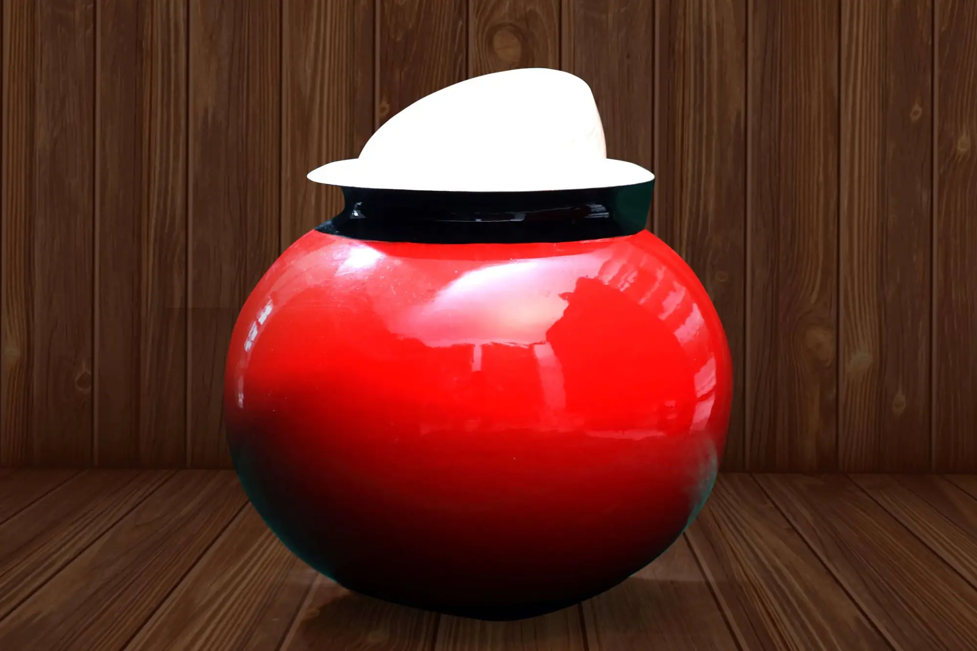 A red pot with a white cloth on top