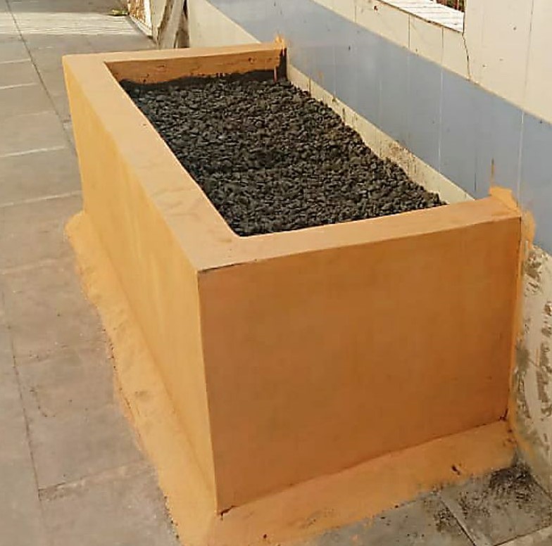 A rectangular planter with soil - type 1