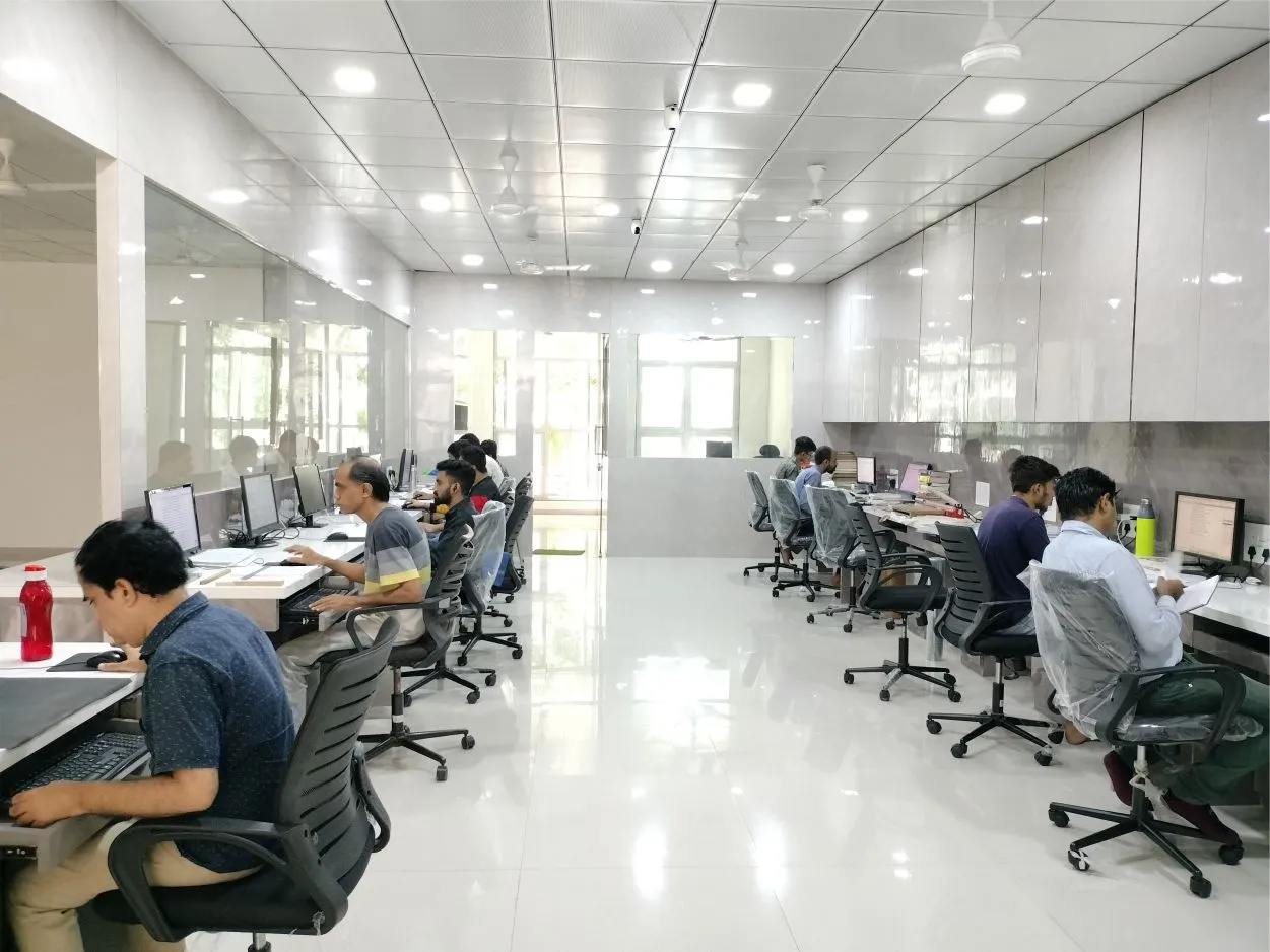A large room with people working at desks